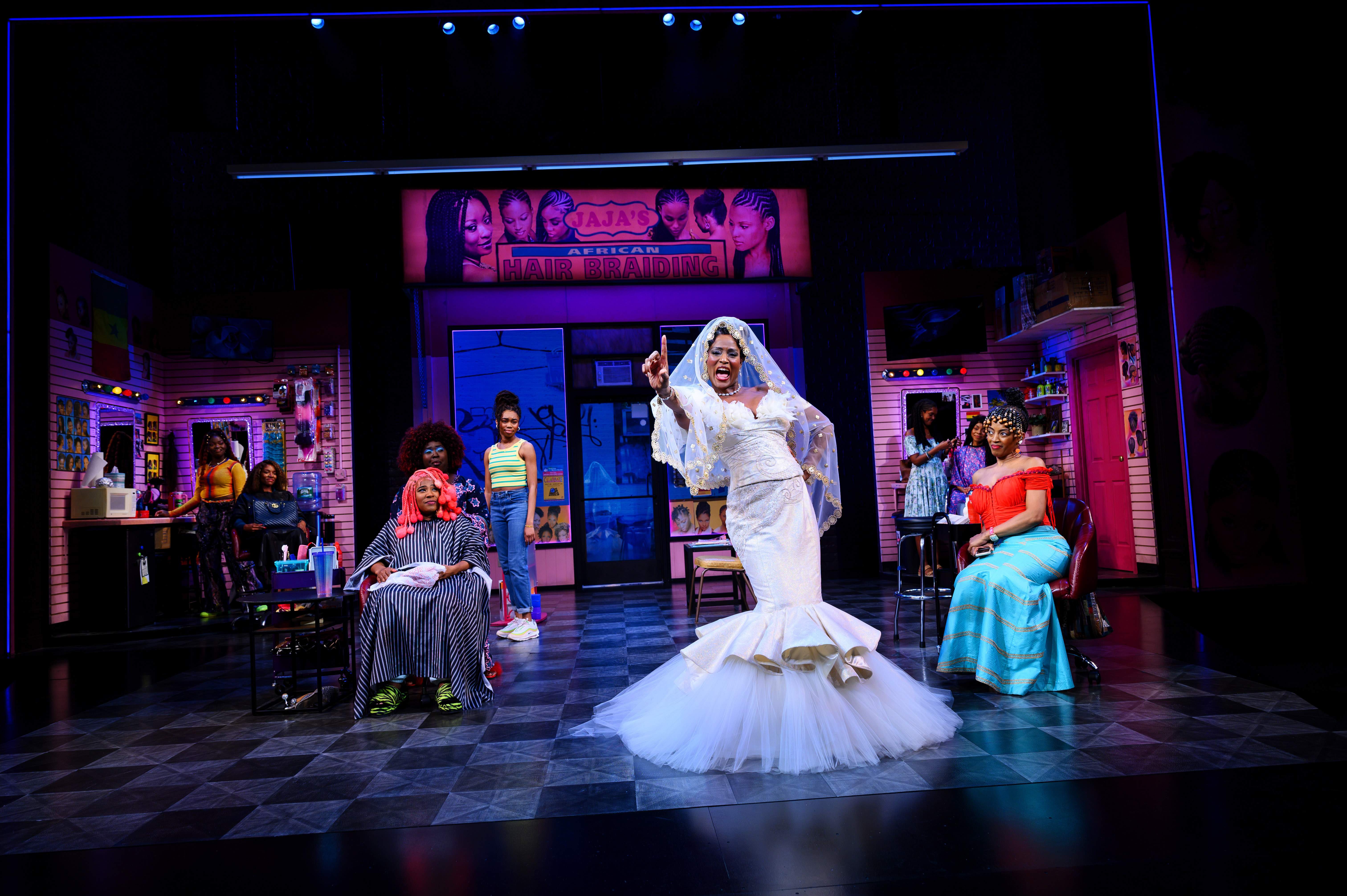 13 Aisha Sougou, Leovina Charles, Melanie Brezill, Awa Sal Secka, Jordan Rice, Victoire Charles, Bisserat Tseggai, Mia Ellis, and Tiffany Renee Johnson in Jaja's African Hair Braiding. (Photo by Ben Krantz Studio/Berkeley Rep)